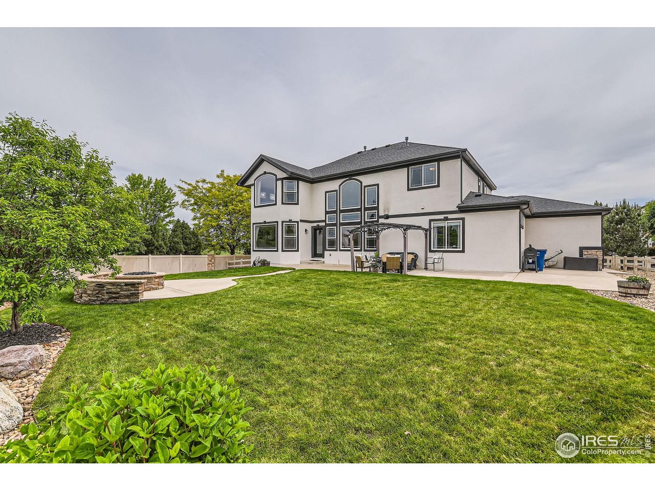 8839 Shetland Drive Frederick, CO 80504 - Photo 37 of 40 a front view of a house with a garden and yard