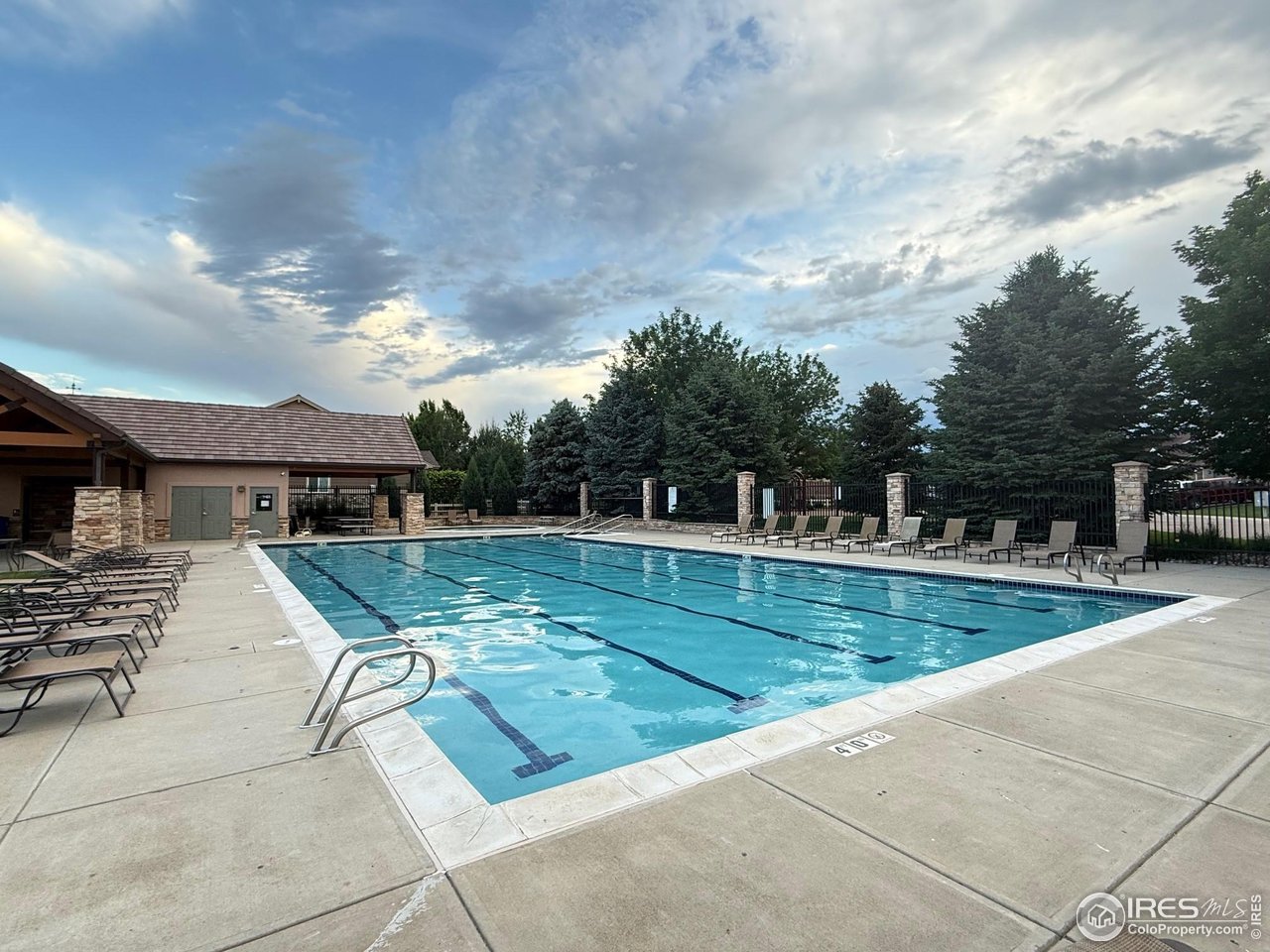 8839 Shetland Drive Frederick, CO 80504 - Photo 40 of 40 a view of swimming pool with a yard and sitting area