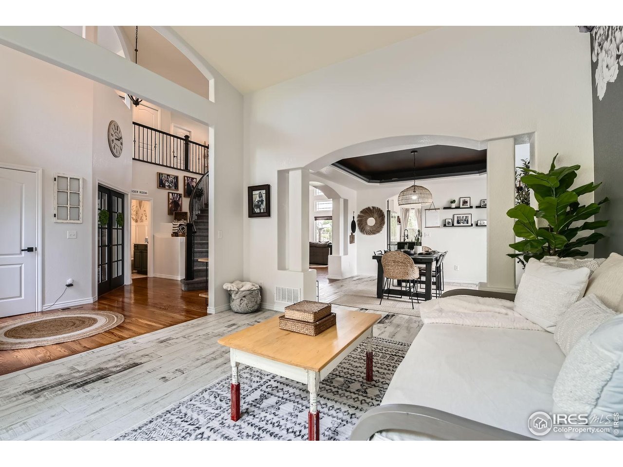 8839 Shetland Drive Frederick, CO 80504 - Photo 6 of 40 a living room with furniture a rug and white walls