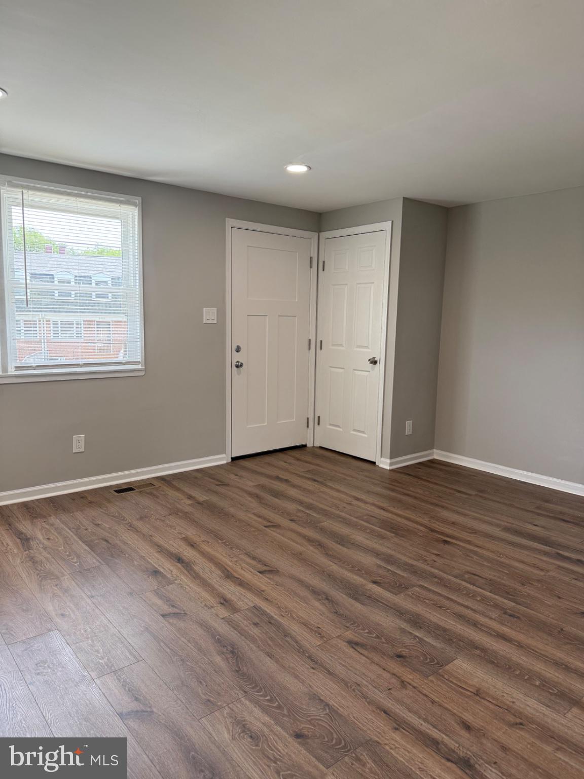 2908 Mallview Road Baltimore, MD 21230 - Photo 5 of 22 a view of an empty room with wooden floor and a window