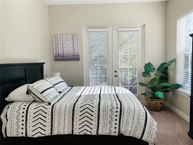 a bedroom with a bed and a potted plant