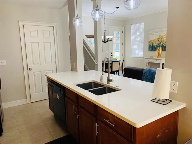 a kitchen with a sink a stove and a refrigerator