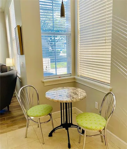 a view of a dining room with furniture and windows
