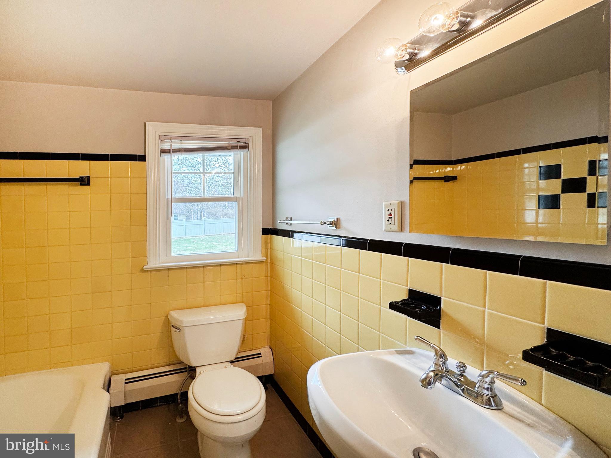 1228 Clyde Road Warminster, PA 18974 - Photo 12 of 19 a bathroom with a sink a toilet and mirror