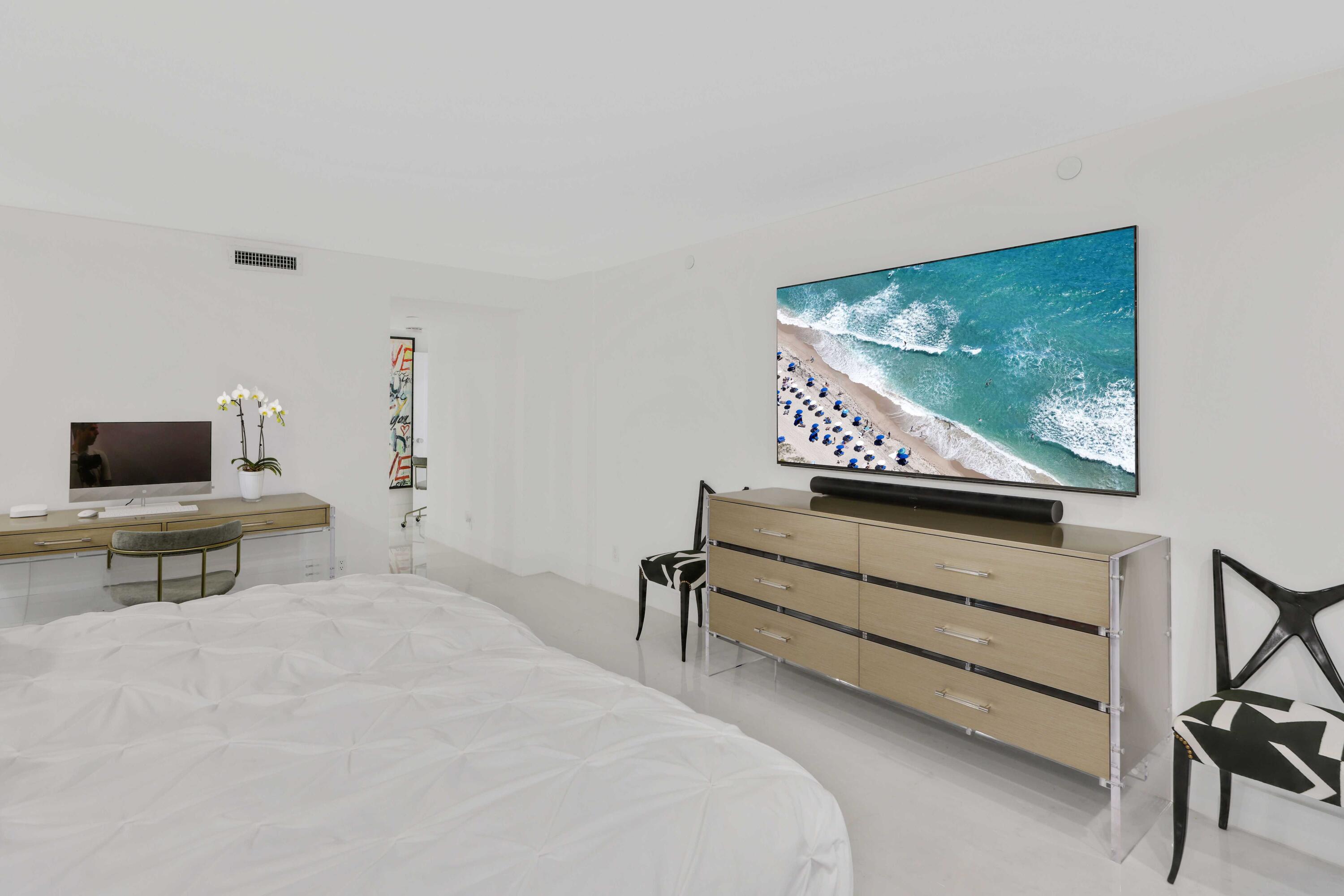 3440 South Ocean Boulevard, Unit 402S Palm Beach, FL 33480 - Photo 14 of 33 a living room with furniture and a flat screen tv