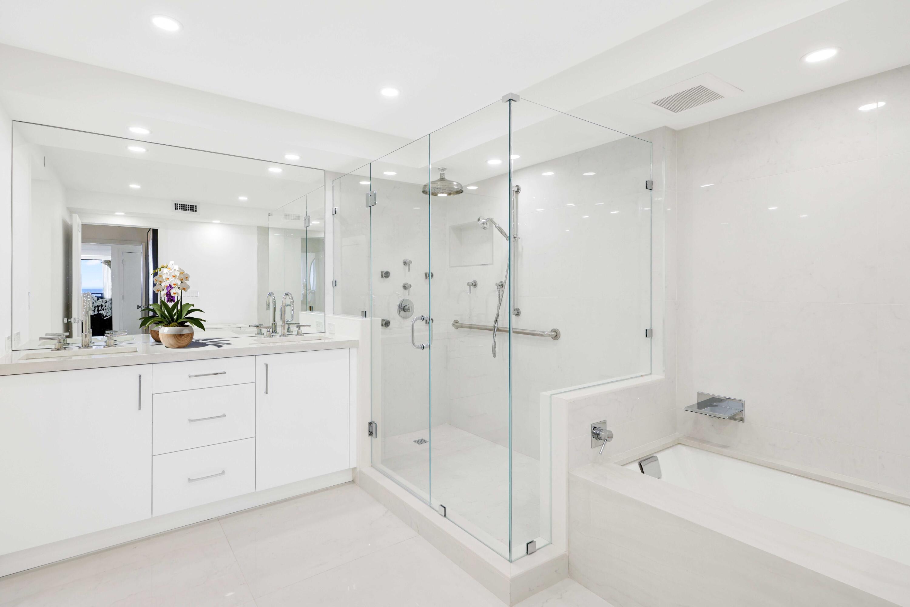 3440 South Ocean Boulevard, Unit 402S Palm Beach, FL 33480 - Photo 16 of 33 a bathroom with a bathtub shower sink vanity and mirror