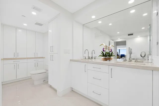 a bathroom with a sink a toilet and mirror