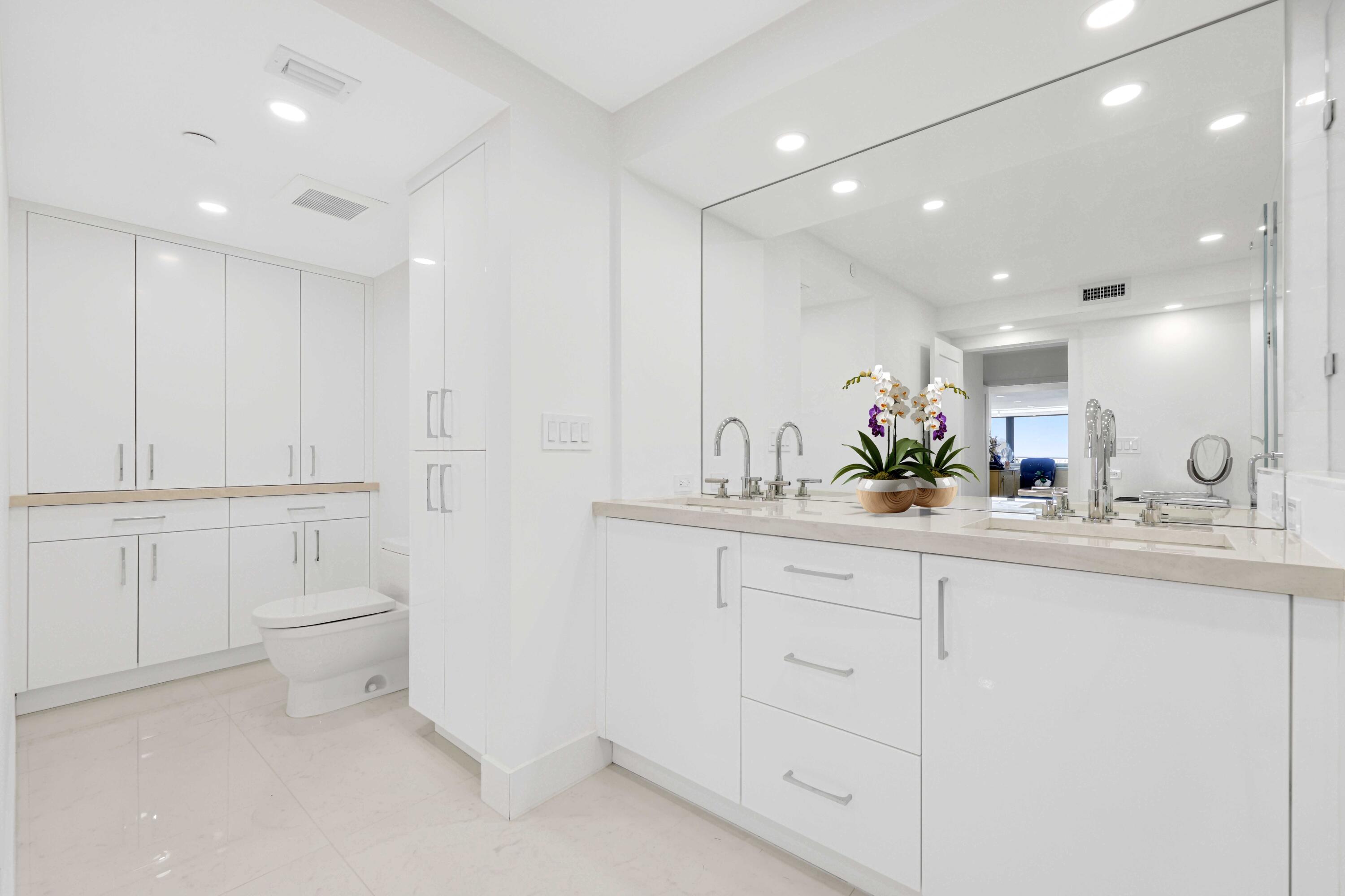 3440 South Ocean Boulevard, Unit 402S Palm Beach, FL 33480 - Photo 17 of 33 a bathroom with a sink a toilet and mirror