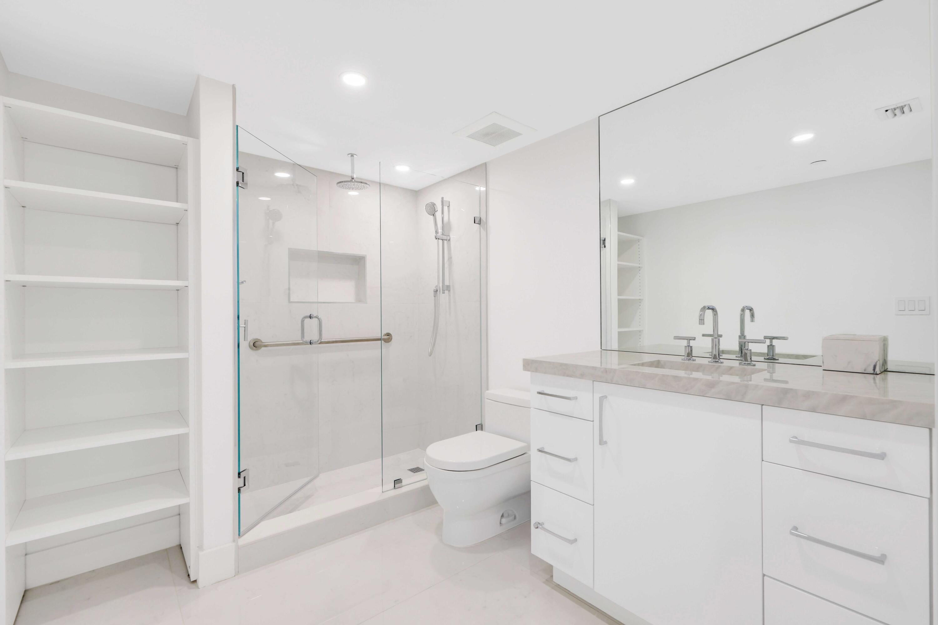 3440 South Ocean Boulevard, Unit 402S Palm Beach, FL 33480 - Photo 19 of 33 a bathroom with a granite countertop sink a toilet and a shower