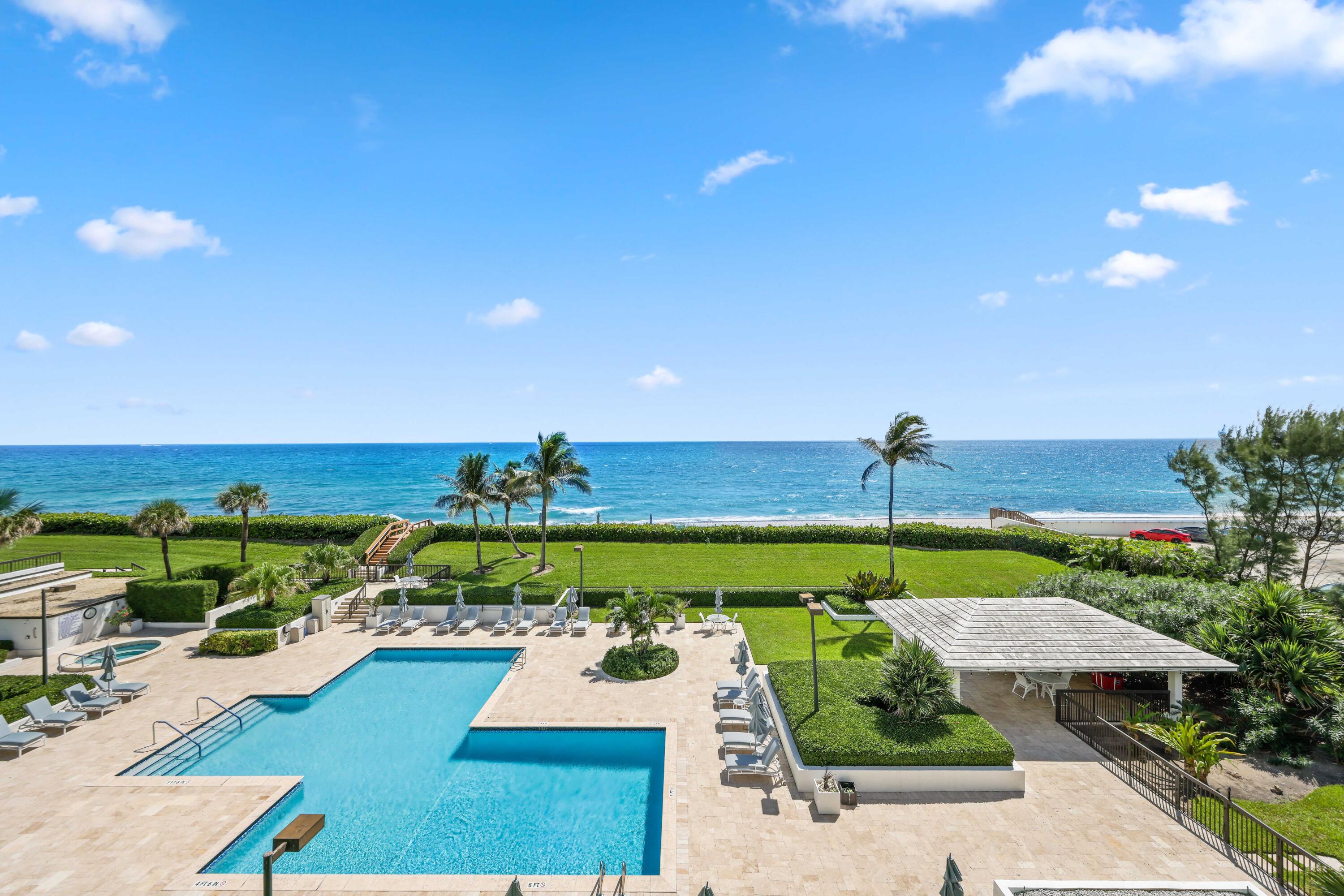 3440 South Ocean Boulevard, Unit 402S Palm Beach, FL 33480 - Photo 25 of 33 a view of a swimming pool with an outdoor seating and a garden