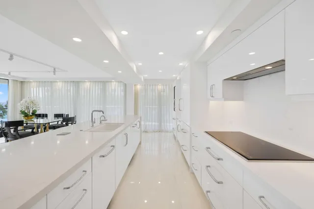 a large white kitchen with a large tub and sink