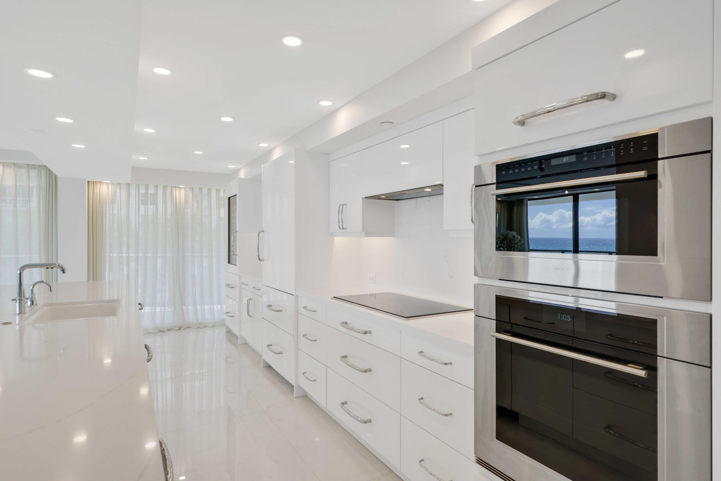 3440 South Ocean Boulevard, Unit 402S Palm Beach, FL 33480 - Photo 9 of 33 a kitchen with stainless steel appliances kitchen island granite countertop a stove and a sink