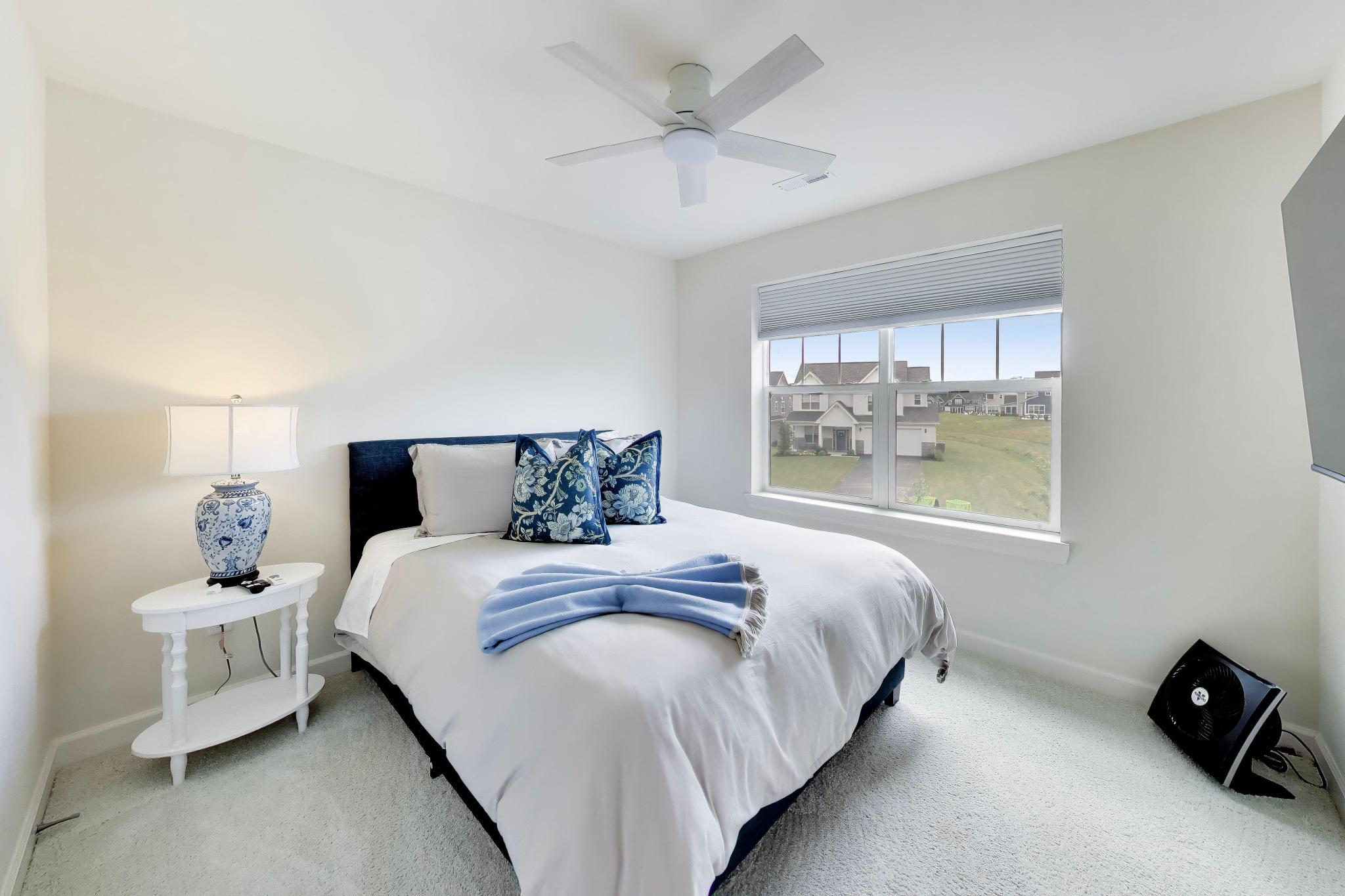 2730 Harbor Court Delavan, WI 53115 - Photo 27 of 47 Upper-level bedroom with private bath, ceiling fan, large window, and neighborhood view.