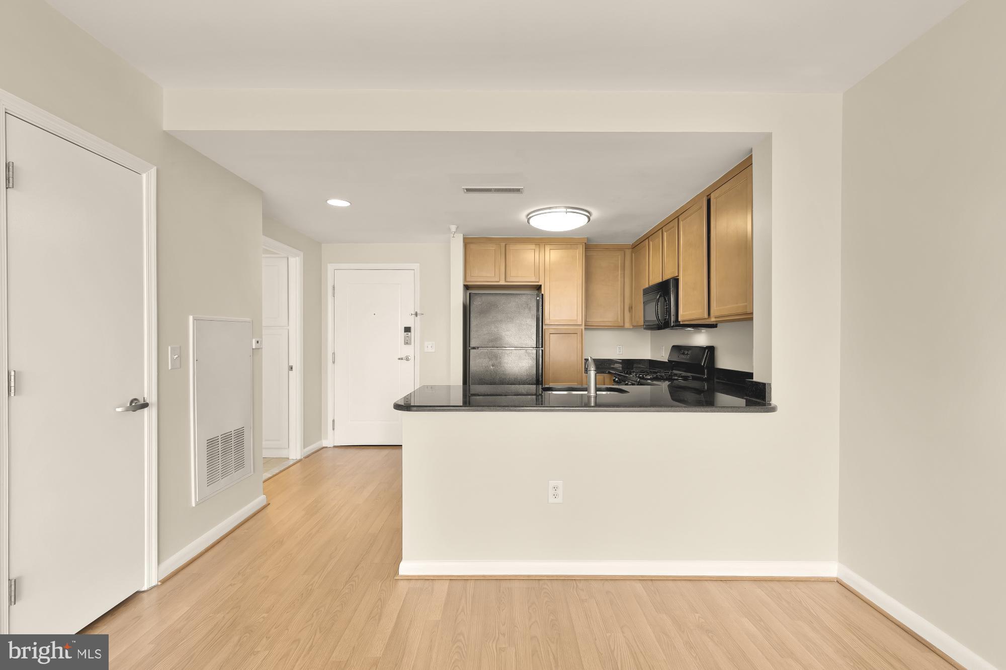 355 I Street Southwest, Unit 621 Washington, DC 20024 - Photo 19 of 34 a large kitchen with a lot of counter space and wooden floor