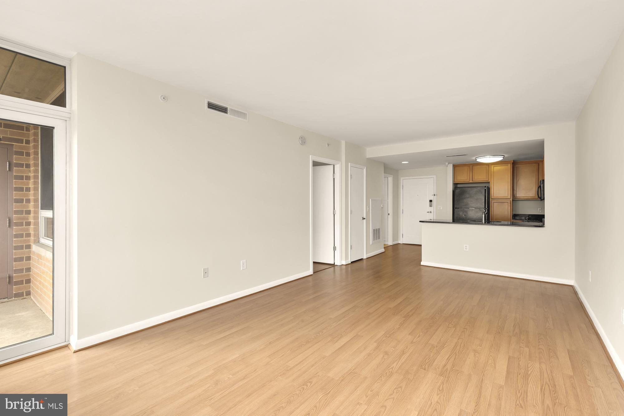 355 I Street Southwest, Unit 621 Washington, DC 20024 - Photo 22 of 34 a view of an empty room with wooden floor and a window