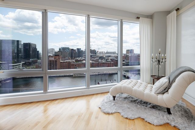 a living room with a large window and a floor to ceiling window