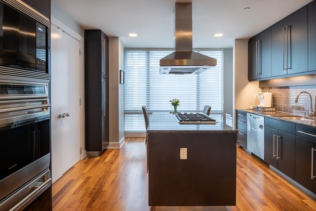 a kitchen with stainless steel appliances granite countertop a stove a sink and a refrigerator