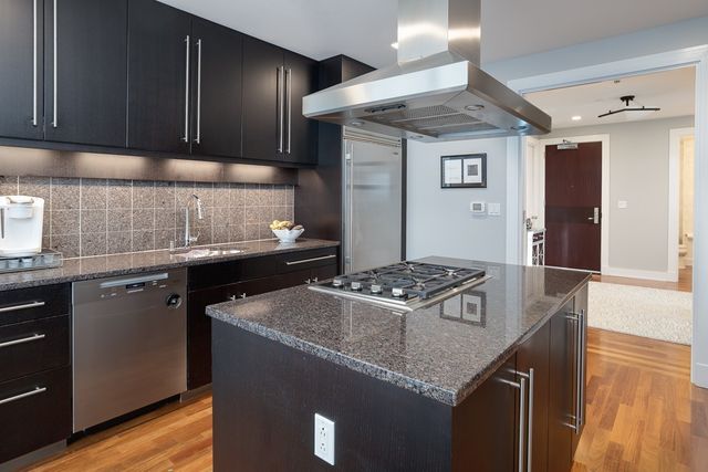 a kitchen with a sink stove and cabinets