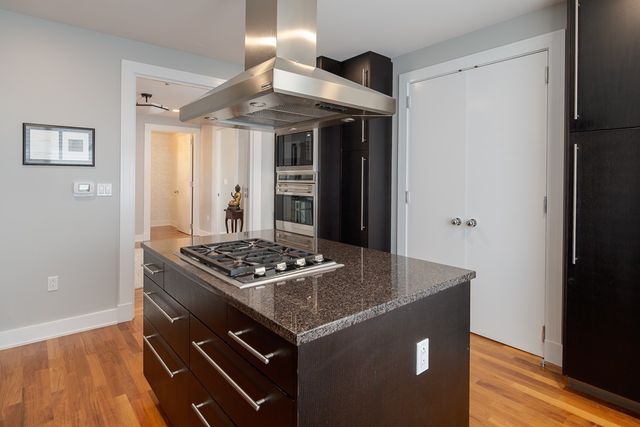a kitchen with stainless steel appliances granite countertop a stove and a refrigerator