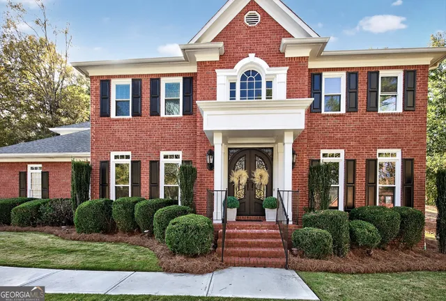 a front view of a house with garden