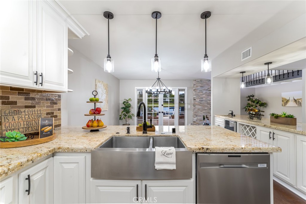 22058 Arrowhead Lane Lake Forest, CA 92630 - Photo 17 of 62 a kitchen with granite countertop a sink a counter space appliances and cabinets