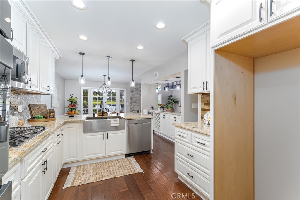 22058 Arrowhead Lane Lake Forest, CA 92630 - Photo 18 of 62 a kitchen with white cabinets and appliances