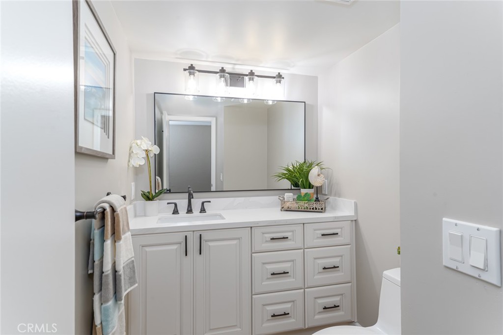 22058 Arrowhead Lane Lake Forest, CA 92630 - Photo 20 of 62 a bathroom with a sink vanity granite and a mirror