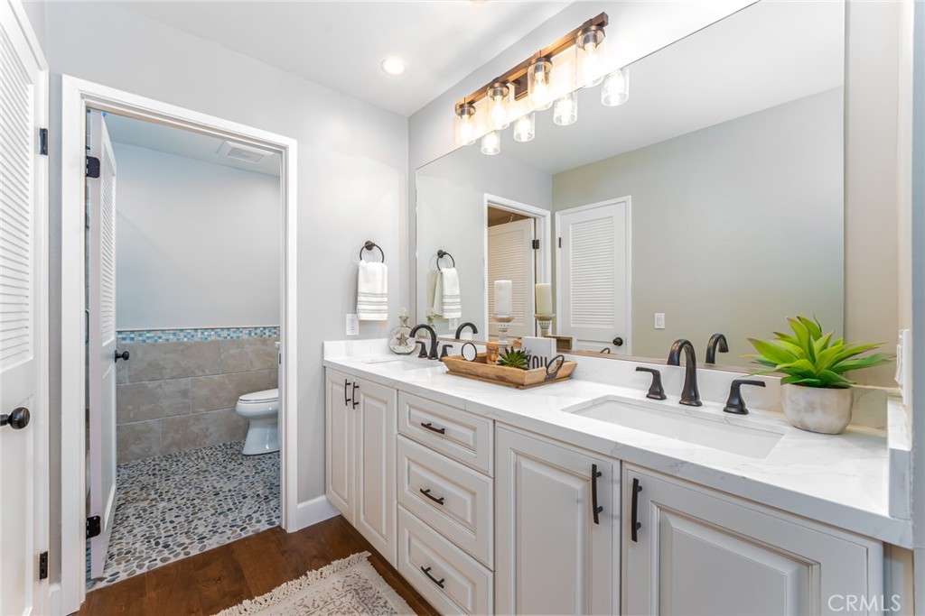 22058 Arrowhead Lane Lake Forest, CA 92630 - Photo 25 of 62 a bathroom with a sink a toilet and shower