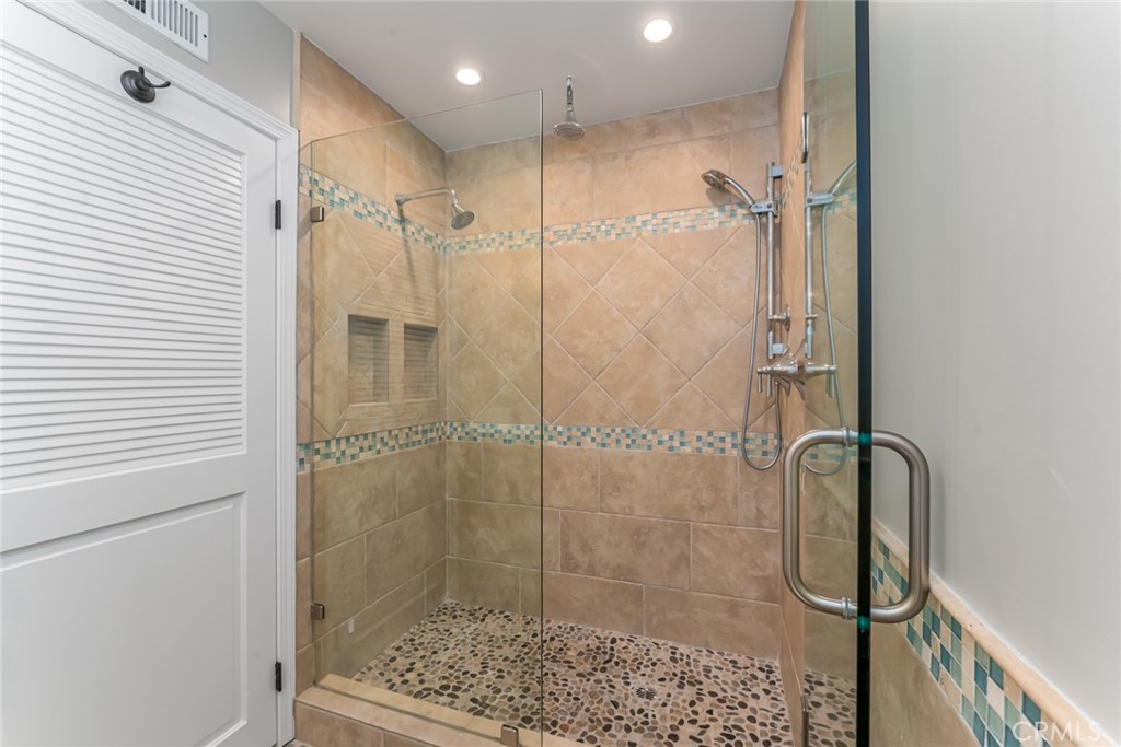 22058 Arrowhead Lane Lake Forest, CA 92630 - Photo 27 of 62 a bathroom with a glass door shower