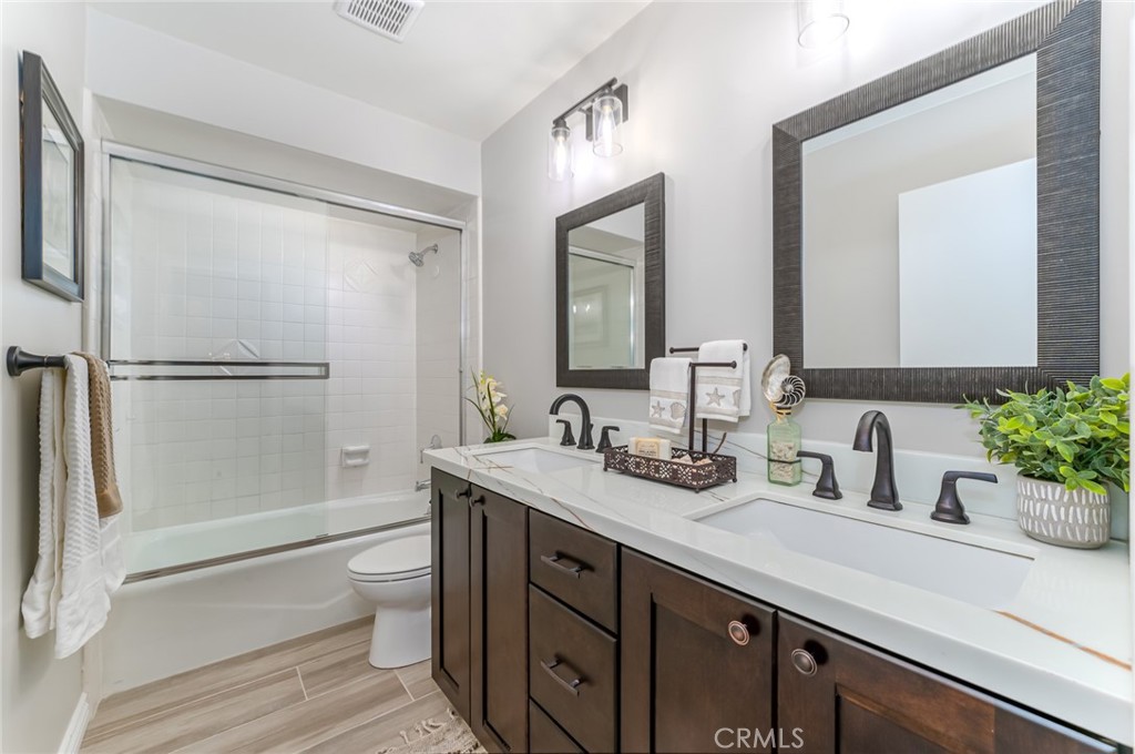 22058 Arrowhead Lane Lake Forest, CA 92630 - Photo 30 of 62 a bathroom with a granite countertop sink mirror vanity and toilet