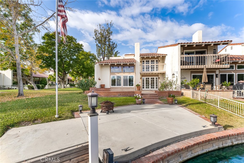 22058 Arrowhead Lane Lake Forest, CA 92630 - Photo 36 of 62 a front view of a house with a yard table and chairs