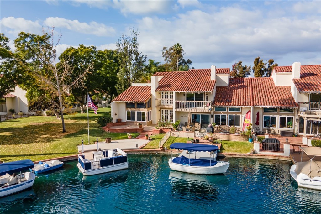 22058 Arrowhead Lane Lake Forest, CA 92630 - Photo 40 of 62 a front view of a house with swimming pool fire pit and outdoor seating