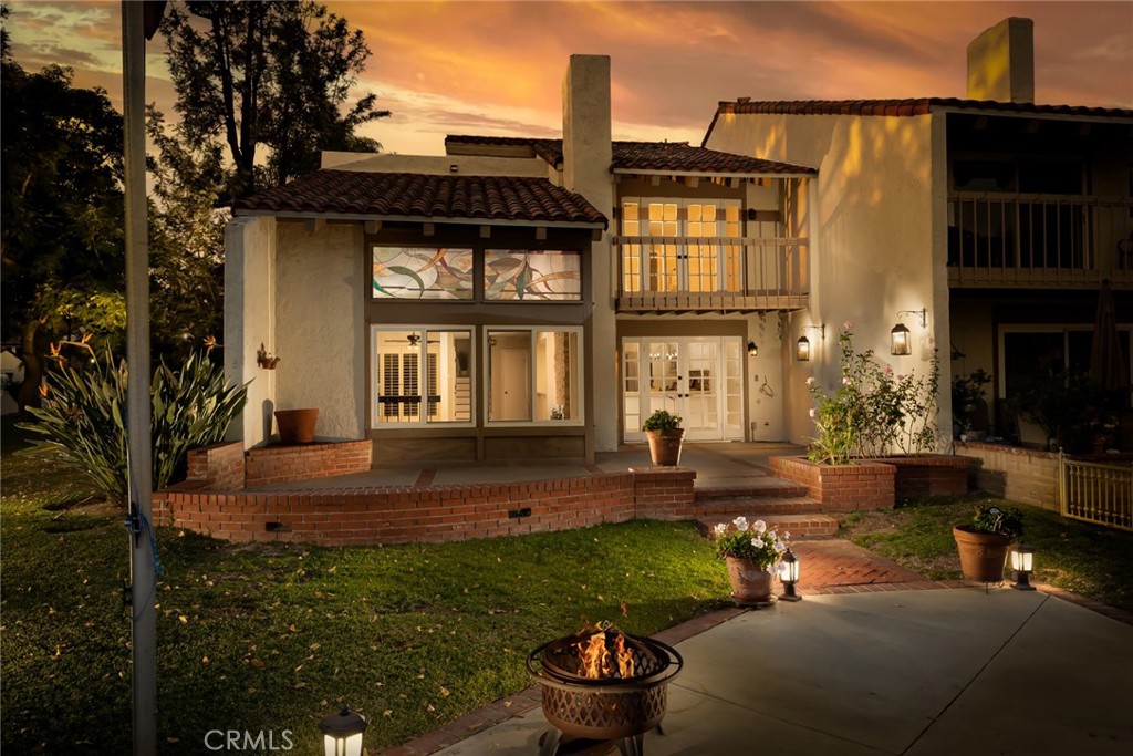 22058 Arrowhead Lane Lake Forest, CA 92630 - Photo 62 of 62 a front view of a house with a yard fire pit and outdoor seating
