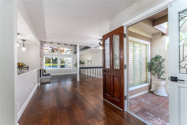 a view of entryway and hall with wooden floor