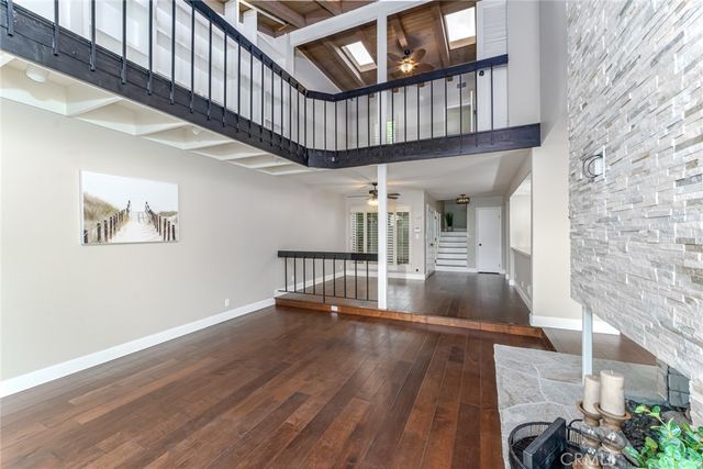 a view of a kitchen center island wooden floor and stainless steel appliances