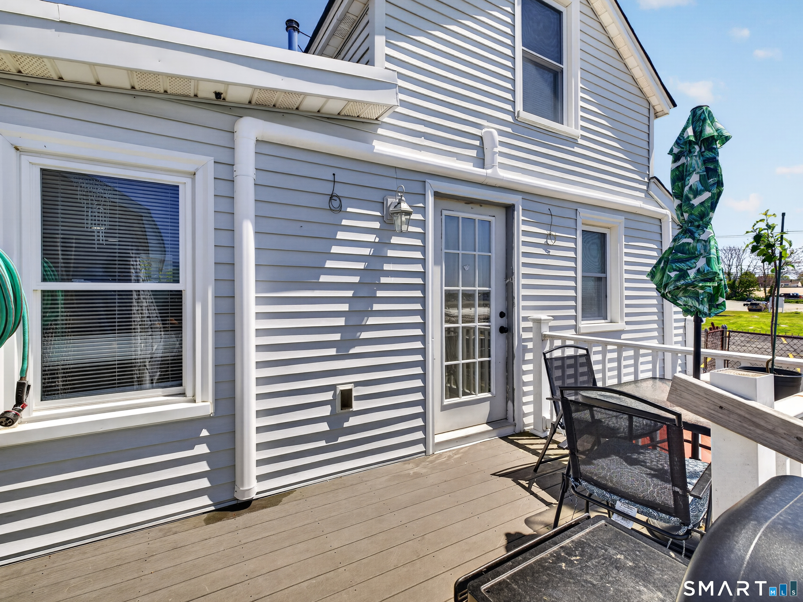 13 Oak Street Groton, CT 06340 - Photo 29 of 38 a view of a patio with table and chairs and wooden floor