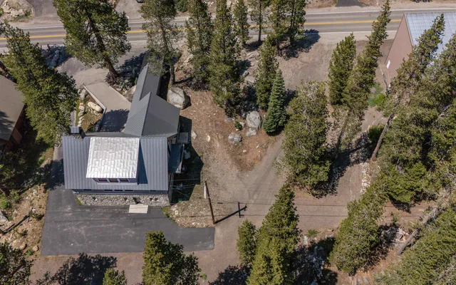 an aerial view of a house with garden space and street view