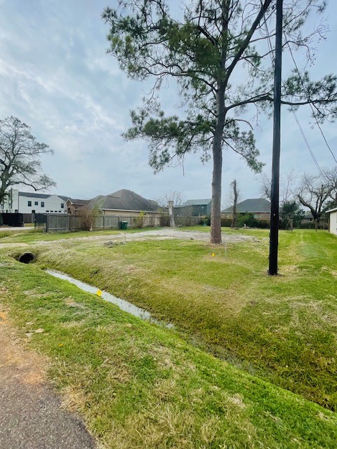 a view of yard with swimming pool and green space