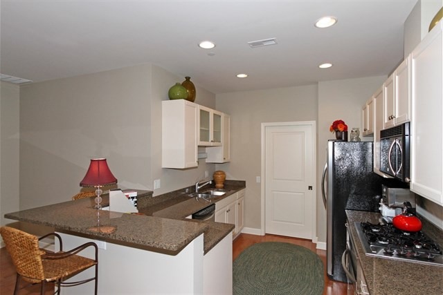 151 West Wing Street, Unit 610 Arlington Heights, IL 60005 - Photo 11 of 21 a kitchen that has a lot of cabinets and refrigerator