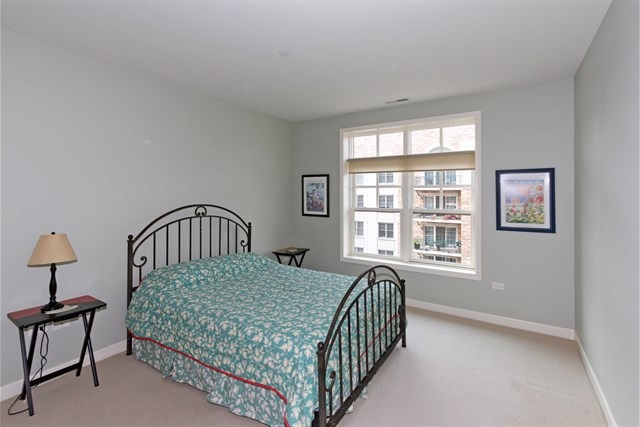151 West Wing Street, Unit 610 Arlington Heights, IL 60005 - Photo 15 of 21 a bedroom with a bed and a window