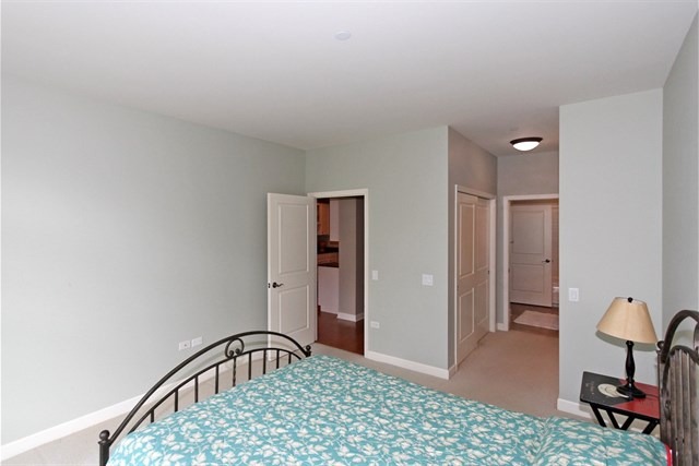 151 West Wing Street, Unit 610 Arlington Heights, IL 60005 - Photo 16 of 21 a bedroom with a bed and a window