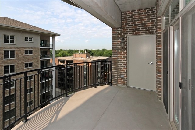 151 West Wing Street, Unit 610 Arlington Heights, IL 60005 - Photo 20 of 21 a view of a balcony with wooden floor and fence