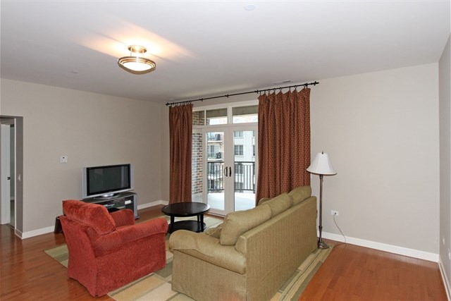 151 West Wing Street, Unit 610 Arlington Heights, IL 60005 - Photo 7 of 21 a living room with furniture and a flat screen tv