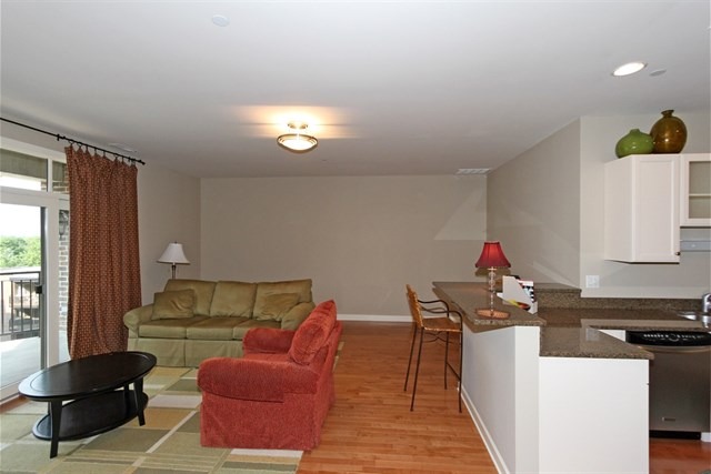 151 West Wing Street, Unit 610 Arlington Heights, IL 60005 - Photo 10 of 21 a living room with furniture and a window