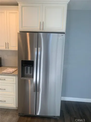 a kitchen with metallic refrigerator freezer and a dishwasher