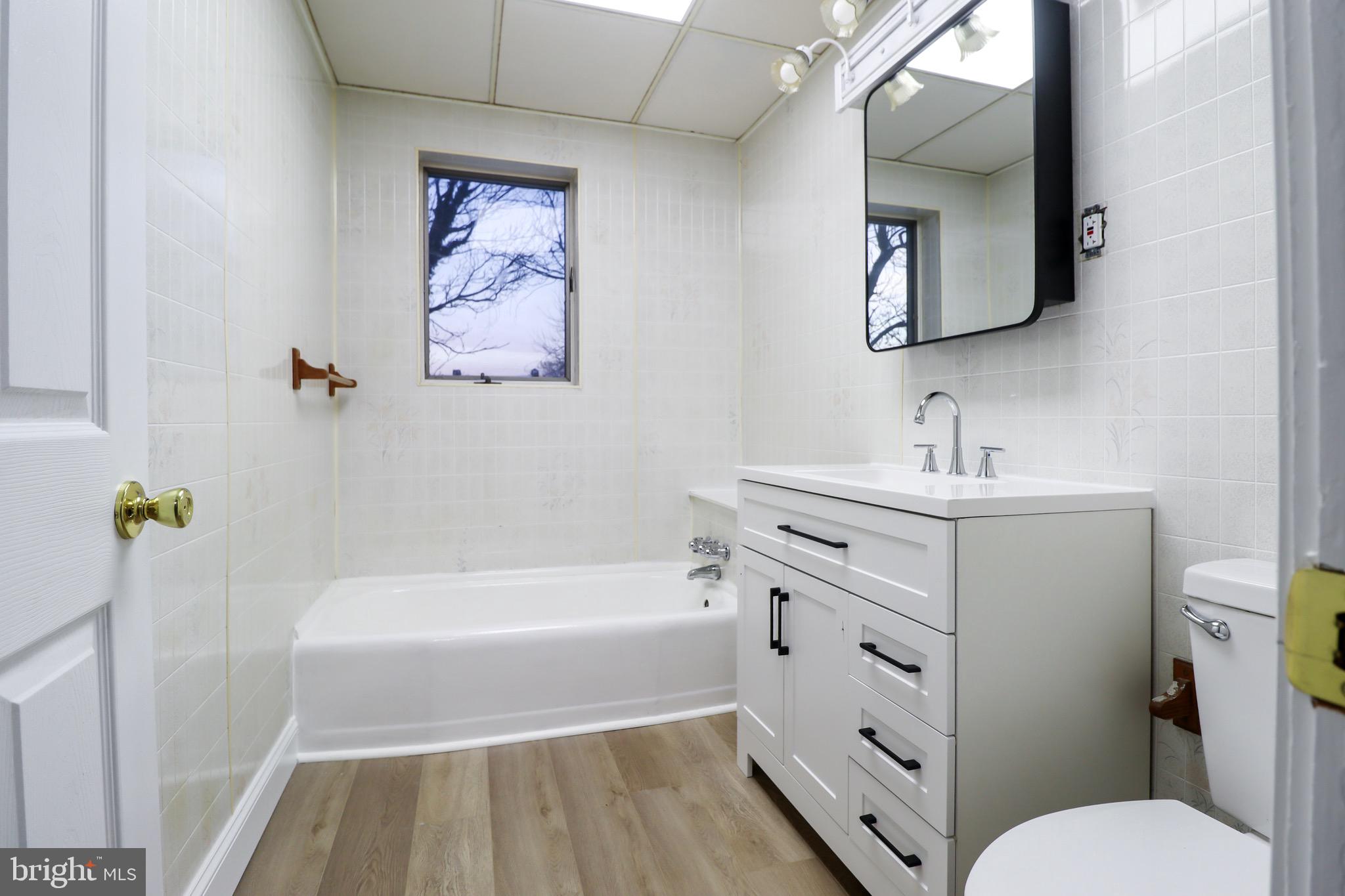 77 7th Street Salem, NJ 08079 - Photo 8 of 15 a bathroom with a sink a toilet and bathtub