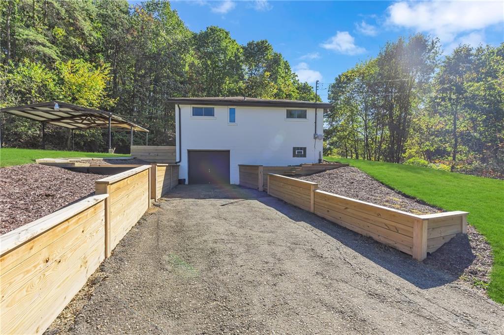 584 Chapel Road Aliquippa, PA 15001 - Photo 27 of 30 Newer retaining walls, with steps on either side for entry into the house.