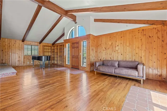a view of an entryway with wooden floor and door