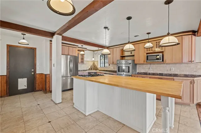 a kitchen with stainless steel appliances granite countertop a stove a sink and a refrigerator