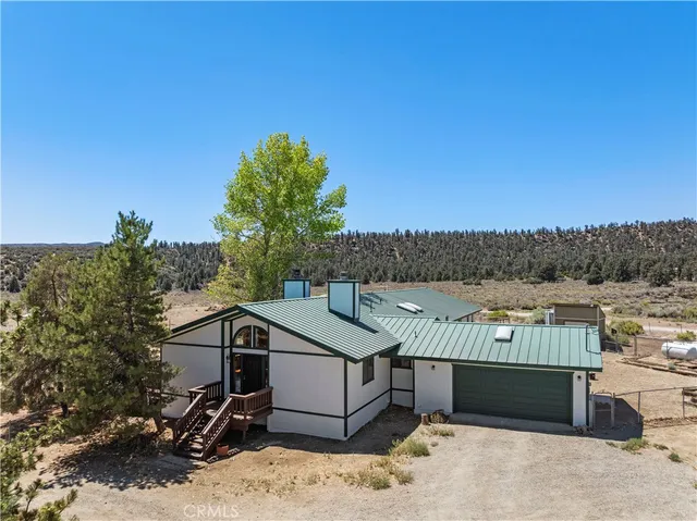 a front view of a house with a yard and a garage